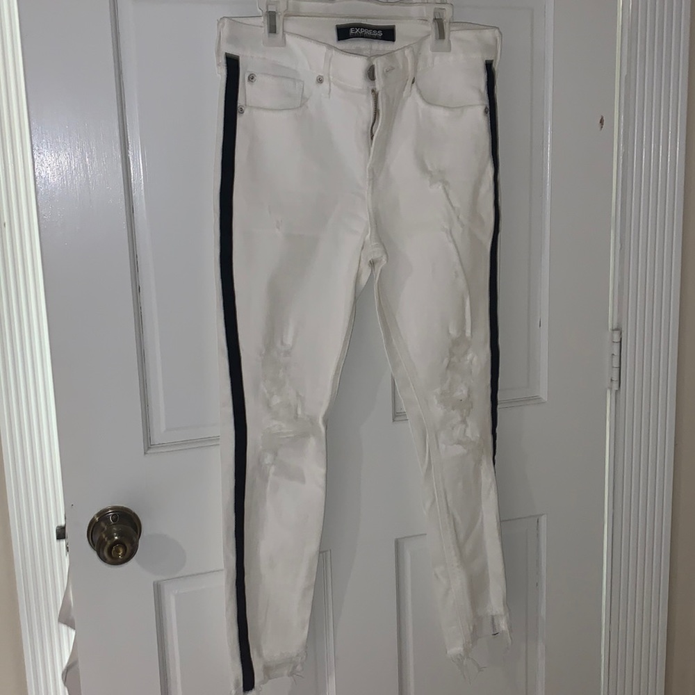 Express White Ripped Jeans with black stripes on the side.